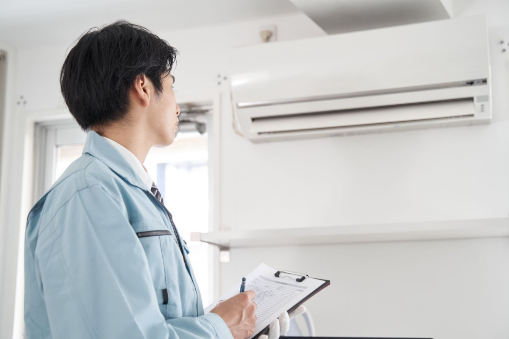 A professional inspecting AC in a home